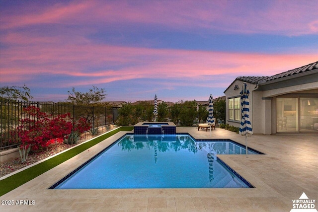 pool at dusk with an in ground hot tub, a patio, and central air condition unit