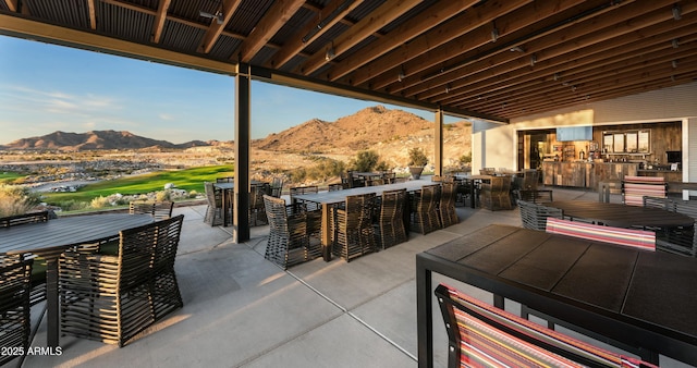 view of patio with a mountain view and a bar