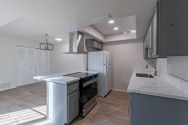 2440 N 22nd Ave, Phoenix, AZ 85009 - kitchen with wall chimney exhaust hood, stainless steel electric range oven, a sink, gray cabinetry, and light wood finished floors