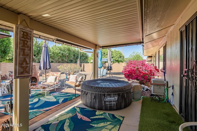 view of patio featuring fence private yard and a hot tub