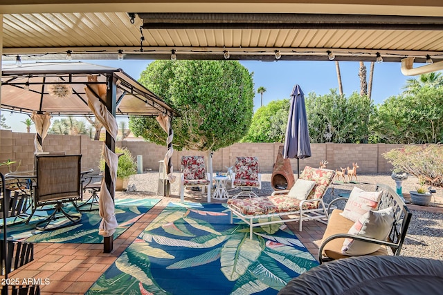 view of patio / terrace with a fenced backyard, a gazebo, outdoor dining area, and outdoor lounge area