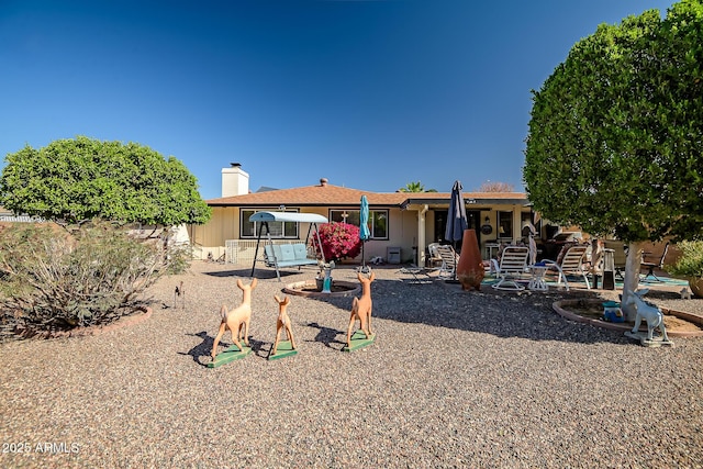view of front of property with a patio and a chimney