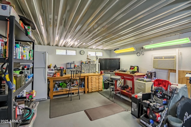 interior space featuring freestanding refrigerator and an AC wall unit