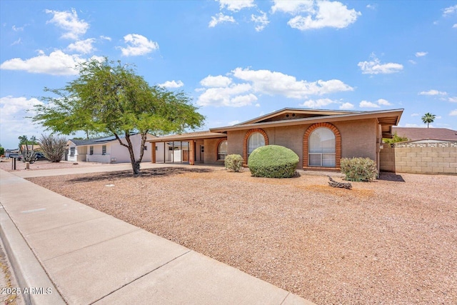 ranch-style home with fence