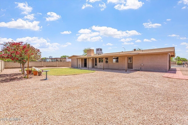 rear view of property with a patio, a fenced backyard, and stucco siding