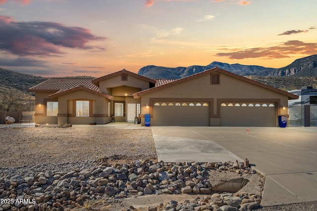 mediterranean / spanish house with a mountain view and a garage