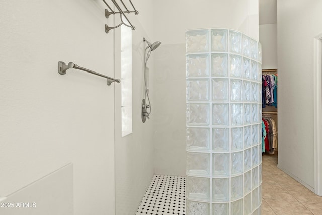 bathroom with tile patterned flooring and walk in shower