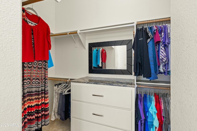 spacious closet with tile patterned floors