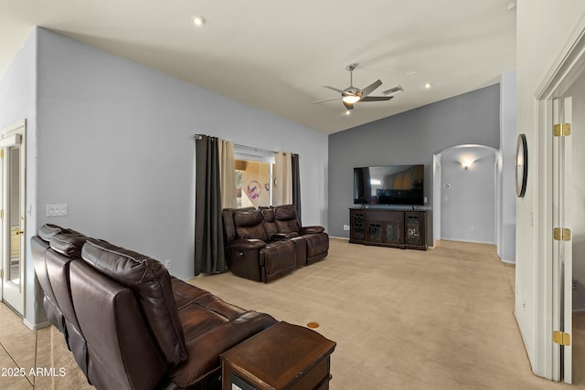 living room featuring vaulted ceiling, light colored carpet, and ceiling fan