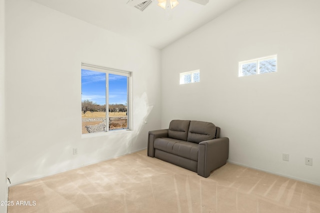 living area featuring high vaulted ceiling, light colored carpet, and ceiling fan