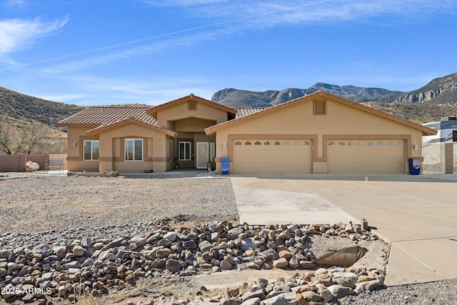 view of front of home featuring a mountain view and a garage