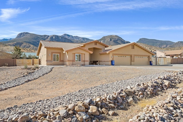 view of front of property with a mountain view and a garage