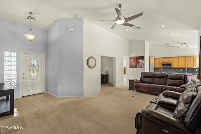 interior space featuring ceiling fan and high vaulted ceiling