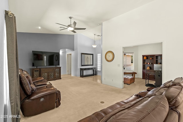 carpeted living room with high vaulted ceiling and ceiling fan