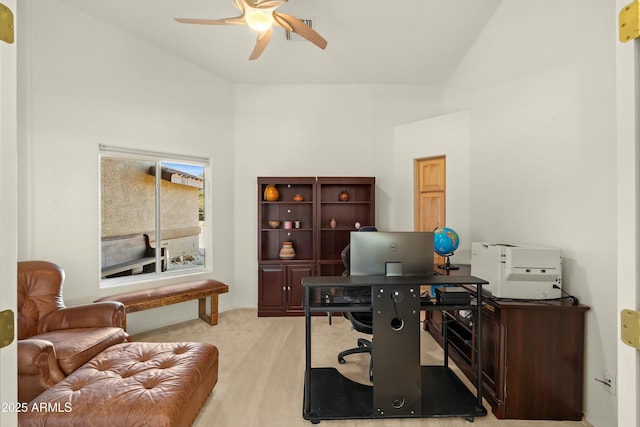 office space with light carpet, high vaulted ceiling, and ceiling fan