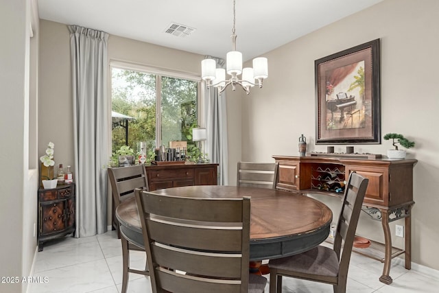 dining room featuring a notable chandelier and visible vents