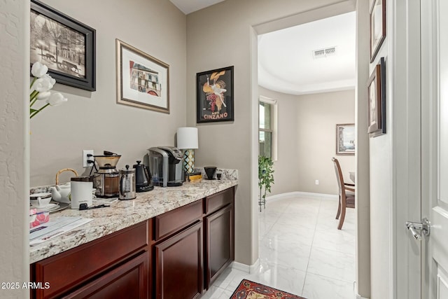 interior space with baseboards and visible vents