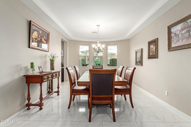 dining space featuring visible vents, baseboards, a notable chandelier, marble finish floor, and a raised ceiling