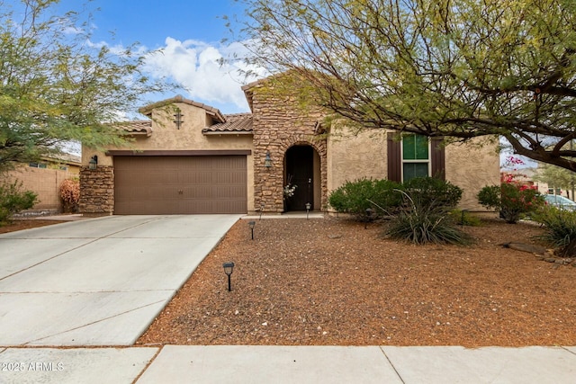 view of front of home featuring a tiled roof, stucco siding, an attached garage, and concrete driveway
