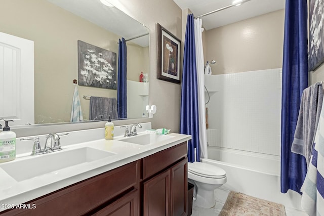 bathroom with double vanity, toilet, shower / bath combo with shower curtain, and a sink