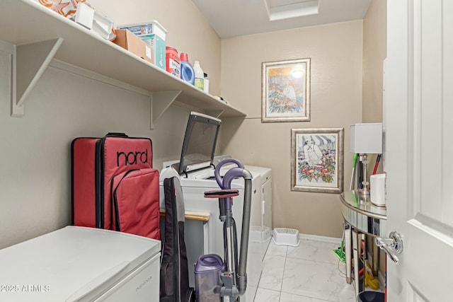 clothes washing area featuring laundry area, baseboards, marble finish floor, and washing machine and clothes dryer