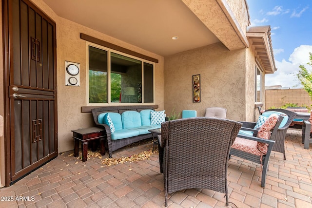 view of patio featuring outdoor lounge area and fence