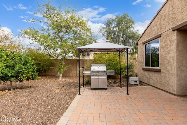 view of patio / terrace featuring a gazebo, area for grilling, and fence