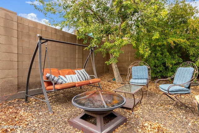 view of patio / terrace with fence and an outdoor fire pit