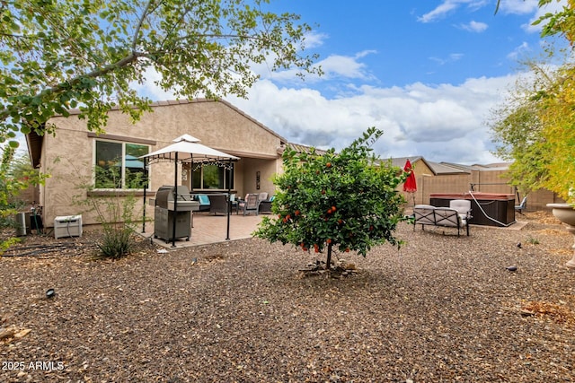 back of house with a gazebo, stucco siding, a patio, and fence
