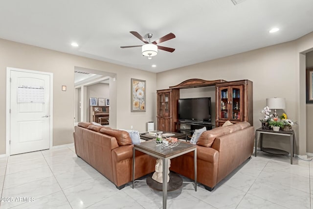 living room with recessed lighting, marble finish floor, baseboards, and a ceiling fan