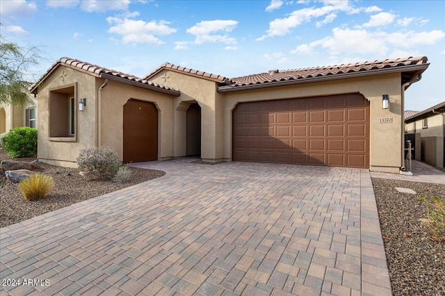 mediterranean / spanish home featuring a garage