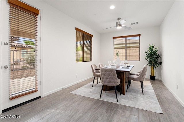 dining room with light wood-type flooring and ceiling fan