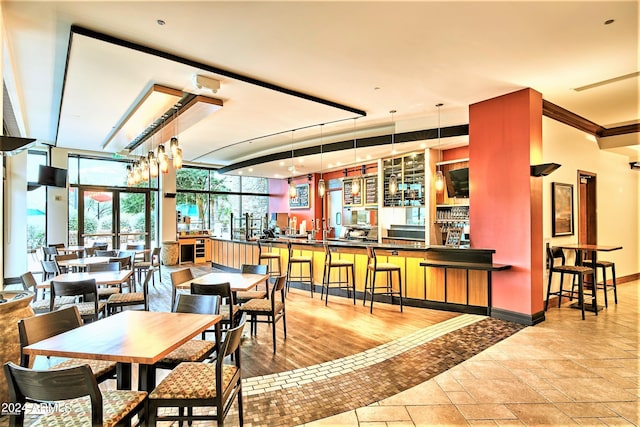 dining room featuring light hardwood / wood-style floors, expansive windows, and crown molding