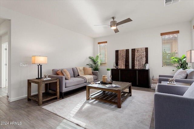 living room featuring ceiling fan and hardwood / wood-style flooring