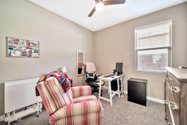 office space with ceiling fan and light carpet