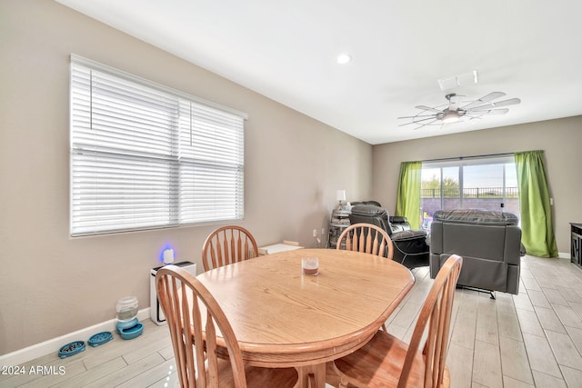 dining area featuring light wood-type flooring and ceiling fan