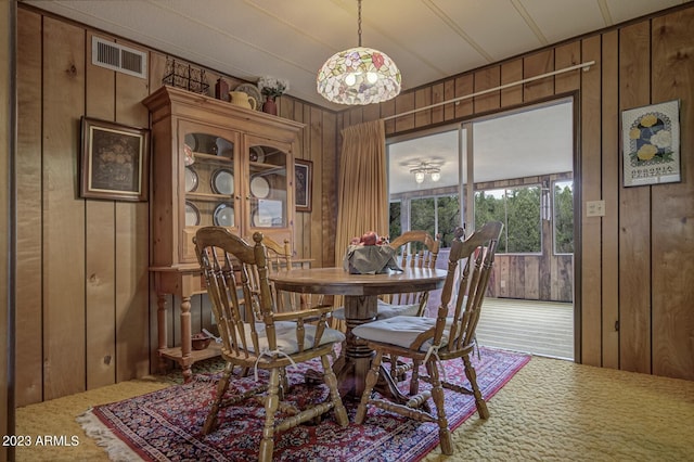 dining area with wooden walls