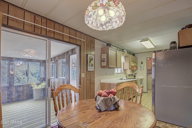 dining room with wooden walls