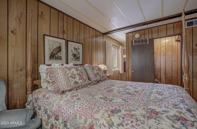 bedroom featuring wood walls