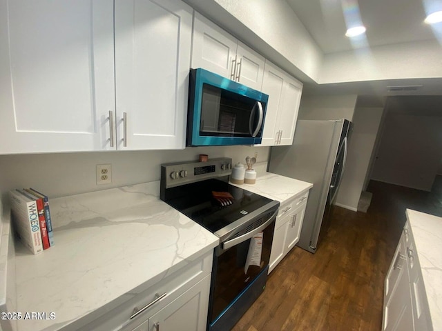 kitchen with dark wood-style flooring, white cabinetry, and stainless steel appliances