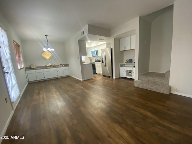 unfurnished living room featuring dark wood-style flooring, baseboards, and visible vents