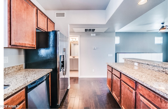 kitchen with light stone counters, ceiling fan, dark wood-type flooring, and appliances with stainless steel finishes