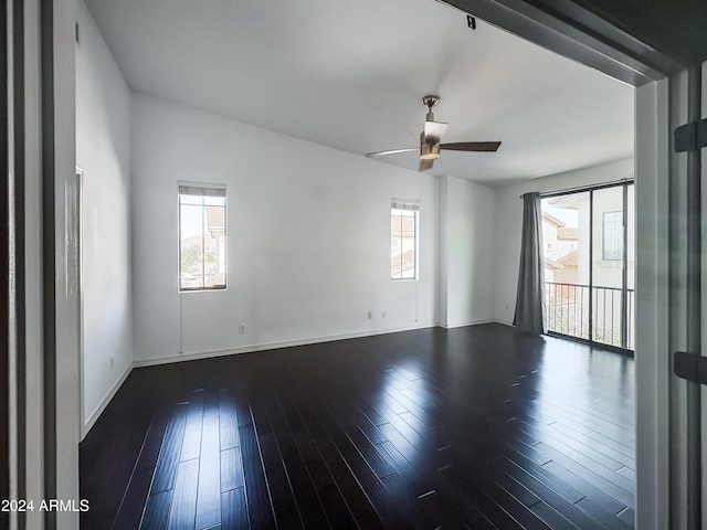 spare room featuring ceiling fan and dark wood-type flooring