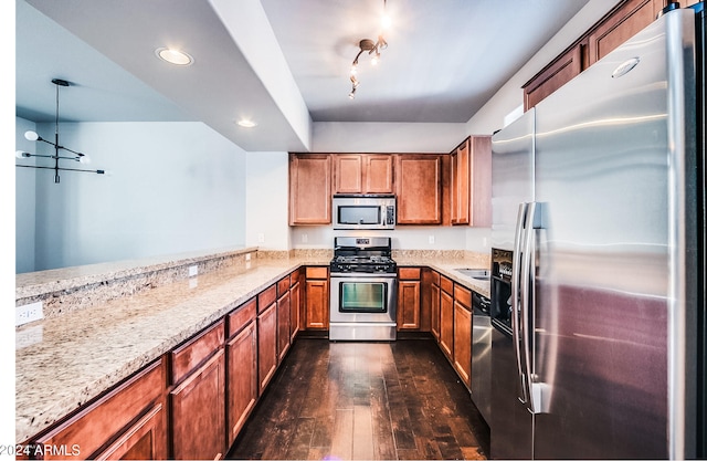 kitchen with light stone countertops, decorative light fixtures, dark hardwood / wood-style flooring, kitchen peninsula, and stainless steel appliances