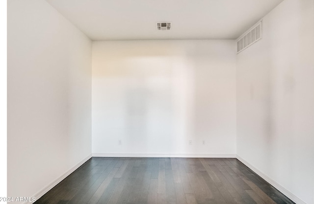 spare room with dark hardwood / wood-style floors