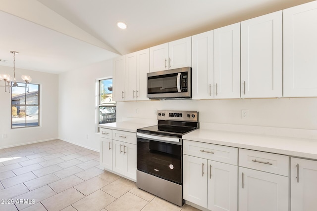 kitchen featuring stainless steel appliances, pendant lighting, and white cabinets