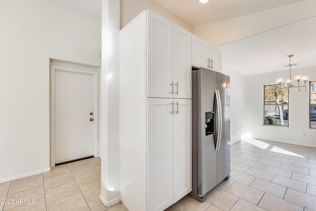 kitchen featuring an inviting chandelier, decorative light fixtures, stainless steel fridge with ice dispenser, light tile patterned floors, and white cabinets