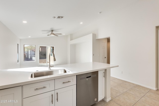 kitchen with vaulted ceiling, light tile patterned flooring, white cabinetry, dishwasher, and ceiling fan