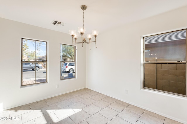 unfurnished dining area with light tile patterned floors and a notable chandelier