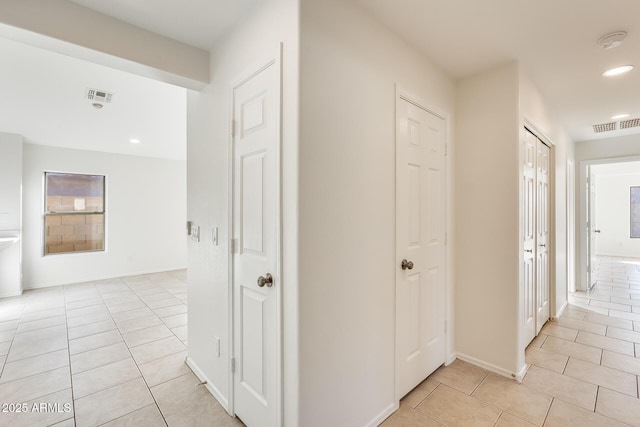 corridor featuring light tile patterned floors